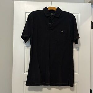 Black polo.  Size M.  Nice fluer-de-lis on the front pocket
